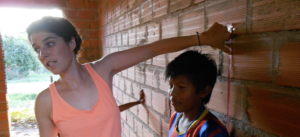 Volunteer talking with a child at the clinic