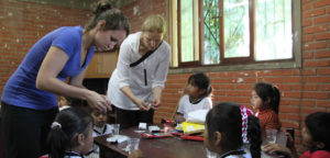 Volunteers working with children at a table