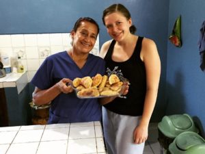 Mumi and a volunteer with freshly baked food